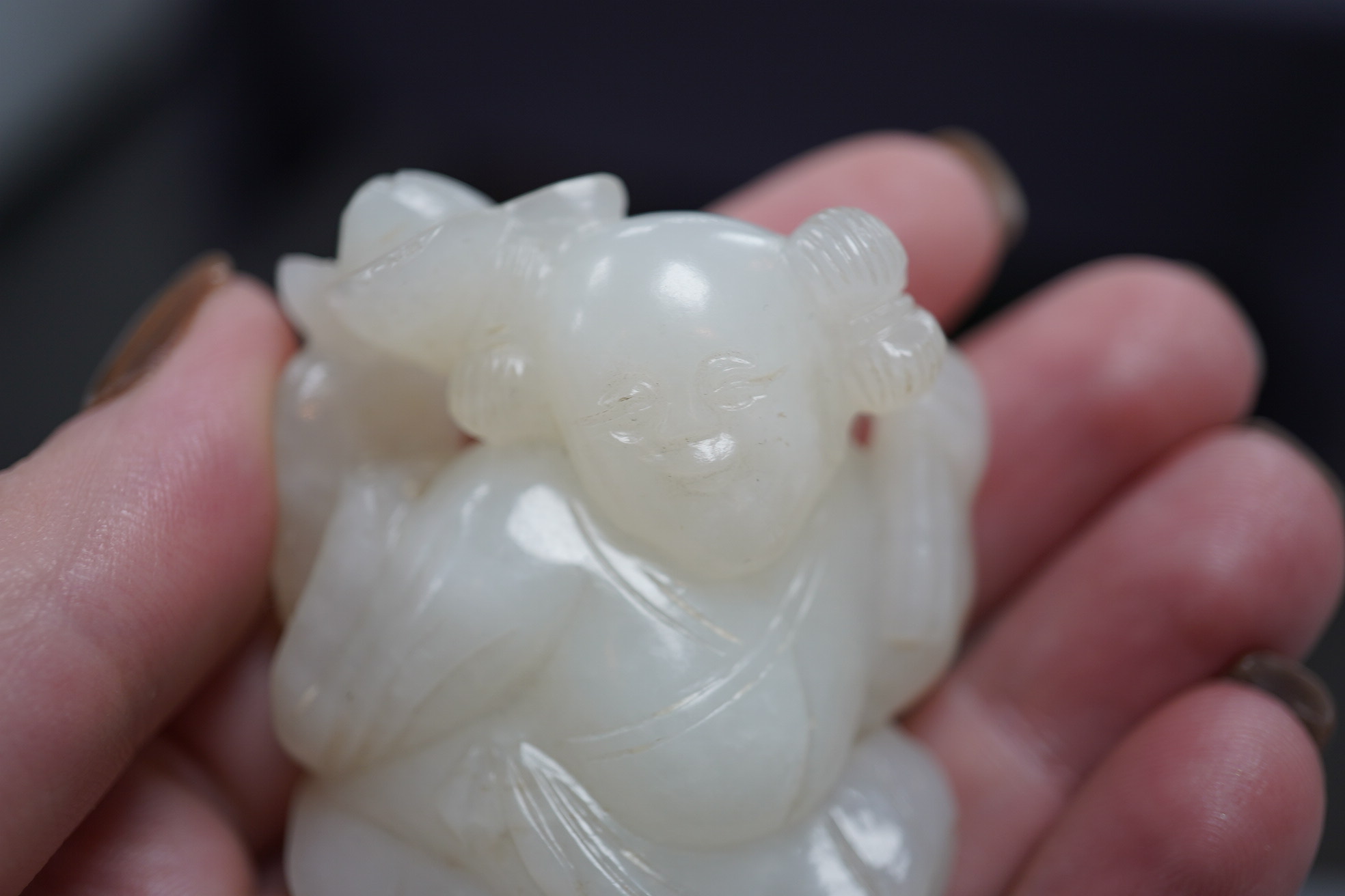 A Chinese white jade figure of a kneeling boy holding lingzhi fungus, 19th century